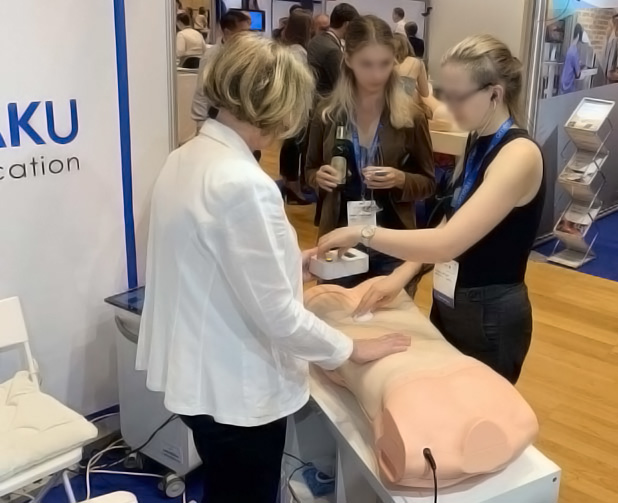 Visitors trying out the AbdoAbby Abdominal Examination Simulator